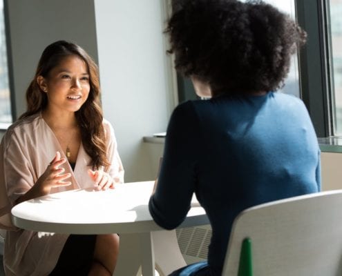 People sitting at table discussing issues